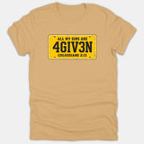 A beige Christian t-shirt featuring a yellow license plate graphic that reads ALL MY SINS ARE 4GIV3N with the scripture reference Colossians 2:13.