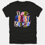 A black T-shirt featuring a vibrant cutout-style collage graphic that reads 'I am CHRIST Encoded' alongside various tech gadget illustrations.