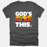 A dark gray Christian T-shirt featuring white text that reads 'GOD'S GOT THIS. ROM 8:28' with a colorful David and Goliath scene graphic within the word GOT.