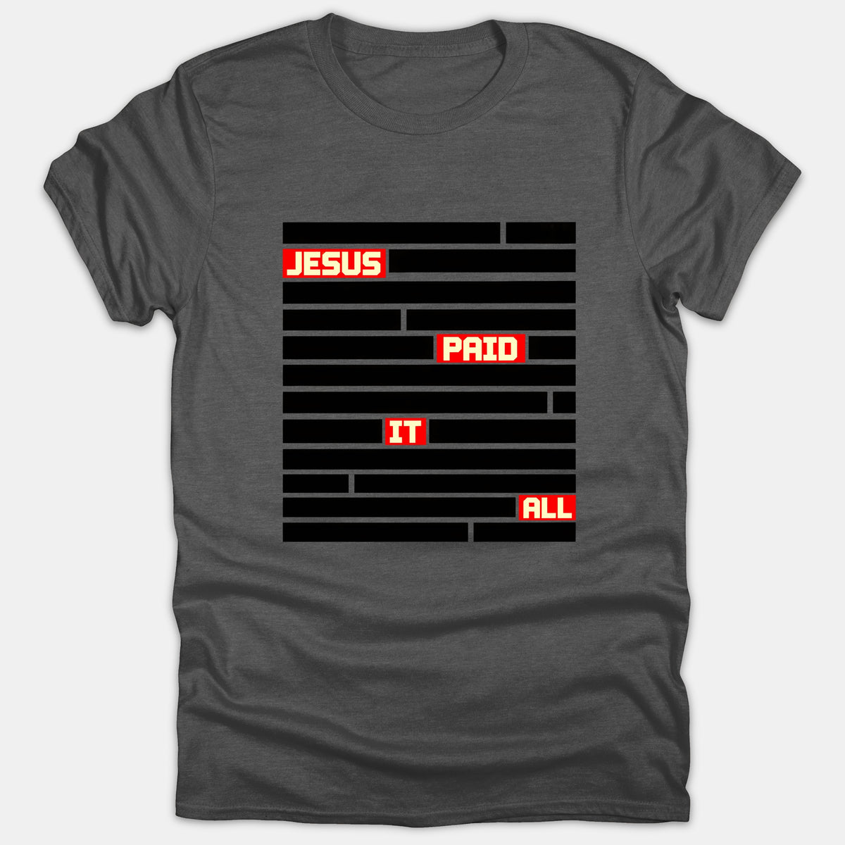 A dark gray t-shirt featuring black redacted lines with highlighted red boxes revealing the phrase 'JESUS PAID IT ALL' in bold white letters.