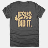 A dark gray Christian t-shirt featuring a bold graphic print that reads 'JESUS DID IT.' accompanied by a swoosh design and a small cross icon.