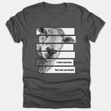 A dark gray t-shirt featuring a sliced graphic design of a sheep with the text, 'I once was lost, but now am found.'