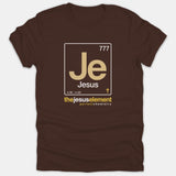 A brown Christian t-shirt featuring a periodic table element design for Jesus with the text the jesus element perfect chemistry printed in white and gold.