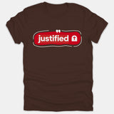 A brown Christian t-shirt featuring a red graphic badge with the word justified in bold white text next to a small cross symbol.