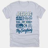 A light gray heather t-shirt displaying stylized blue typography that describes Jesus with names like My Best Friend, My King, and My Everything alongside a Scripture reference.