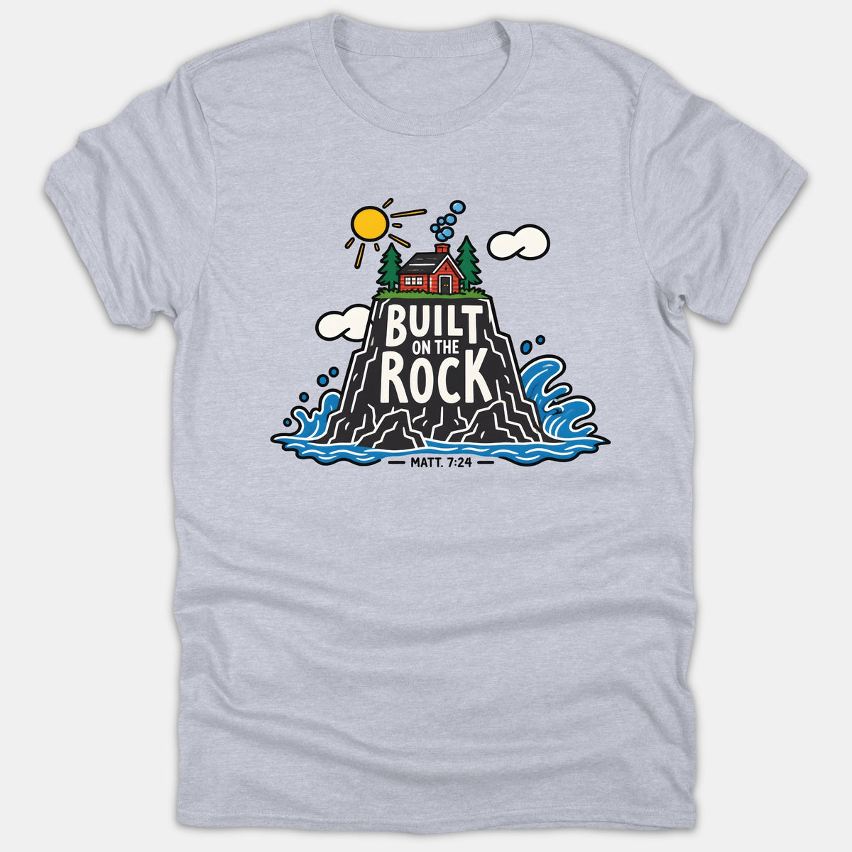 A gray t-shirt featuring an illustration of a red house built on a tall rock surrounded by ocean waves, with the text Built On The Rock Matt. 7:24.