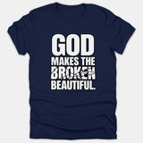 A navy blue Christian t-shirt featuring bold typography that reads 'GOD MAKES THE BROKEN BEAUTIFUL' with a shattered glass effect on the word BROKEN.