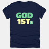 A navy blue Christian t-shirt printed with the phrase GOD 1ST in bold green and yellow lettering alongside a small cross graphic.