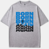 A heather gray Christian t-shirt featuring the stacked text 'Born Again' in bold blue and black graphic typography, with a small cross inside the letter O.