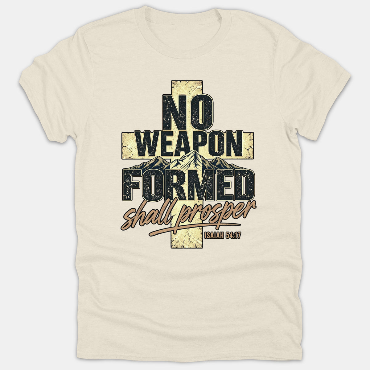A beige Christian graphic t-shirt featuring a textured cross filled with mountain scenery and the scripture quote 'No Weapon Formed Shall Prosper Isaiah 54:17' in vintage style text.