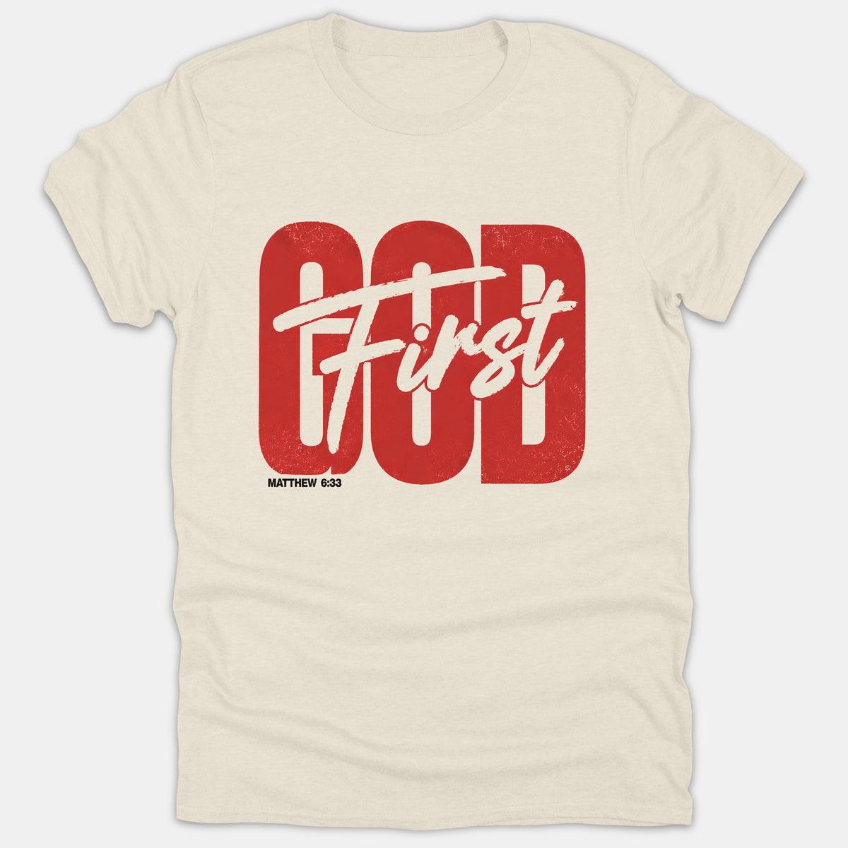 A beige Christian t-shirt featuring the bold red word GOD overlaid with white script text reading First and the reference MATTHEW 6:33 printed below.