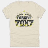 A beige graphic t-shirt with a distressed Christian design featuring a cross, crown, crown of thorns, and bold text reading Forgive Not 7 Times 70X7 Matthew 18:21-22.