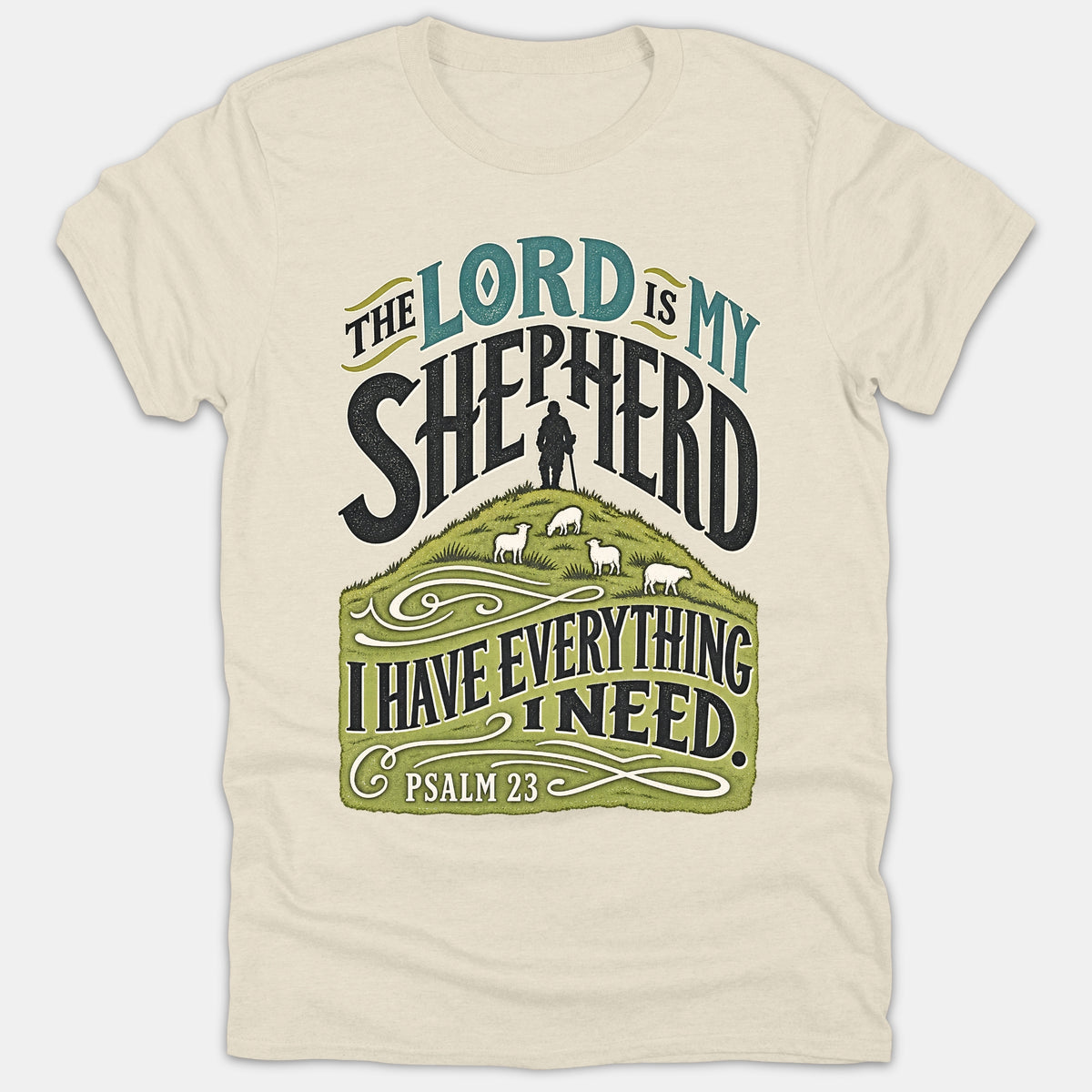 A beige Christian t-shirt featuring Psalm 23 scripture artwork that reads The Lord Is My Shepherd above an illustration of a shepherd leading sheep on a green hill.