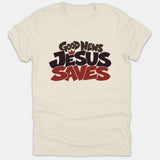 A beige Christian t-shirt featuring a bold graphic design with the text 'GOOD NEWS JESUS SAVES' in black and red typography.