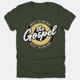 A green t-shirt featuring a circular badge design with the text 'Amplify The Good News' surrounding 'the Gospel' written in white script at the center.