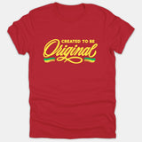 A red t-shirt featuring the yellow text "CREATED TO BE Original" in stylized typography with green and yellow brushstroke accents underneath.