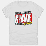 A white Christian t-shirt featuring a graphic design that reads 'SAVED BY GRACE FUELED BY FAITH' in bold red, black, and yellow typography.
