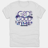A white Christian t-shirt featuring a purple and blue galaxy-style graphic with the text 'God Is Good All The Time', a cross, crown, skyline, and Psalm 100:5 scripture reference.