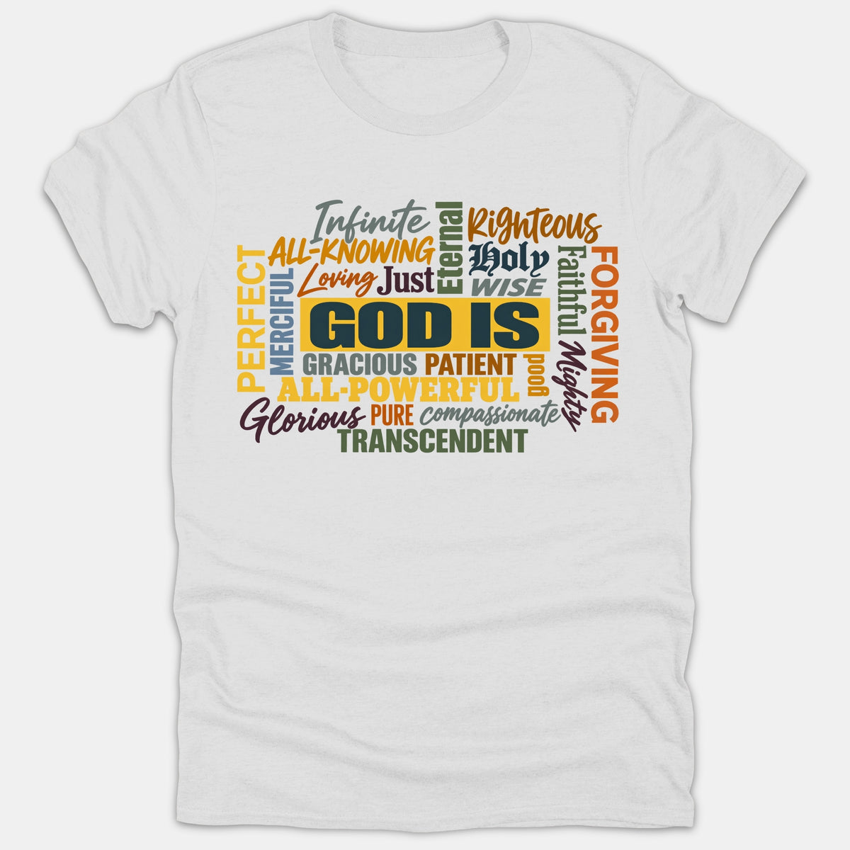 A white t-shirt displaying a vibrant typography word cloud centered on the phrase GOD IS, surrounded by descriptive attributes like Holy, Righteous, Faithful, and Gracious.